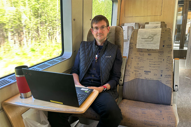 En pendlare som sitter med datorn ombord på Regina.